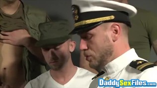 Bearded mature tastes cum after deepthroating young soldiers